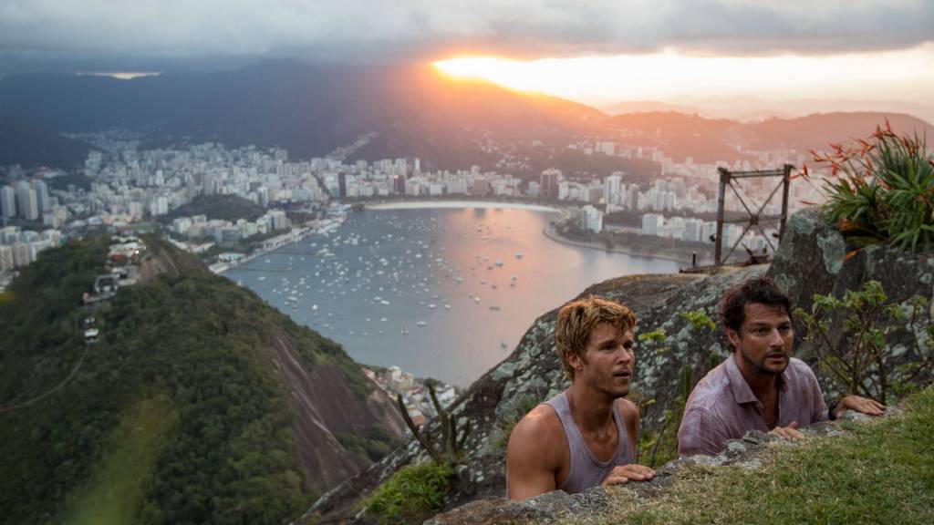 MV5BMjc1Y2FlZjktMWE0Yi00MzMxLWEwNmYtYjU5ZDU4NTdhMTZiXkEyXkFqcGdeQXVyMTkzODUwNzk@._V1_ Foto mostra dois homens fazendo uma trilha
