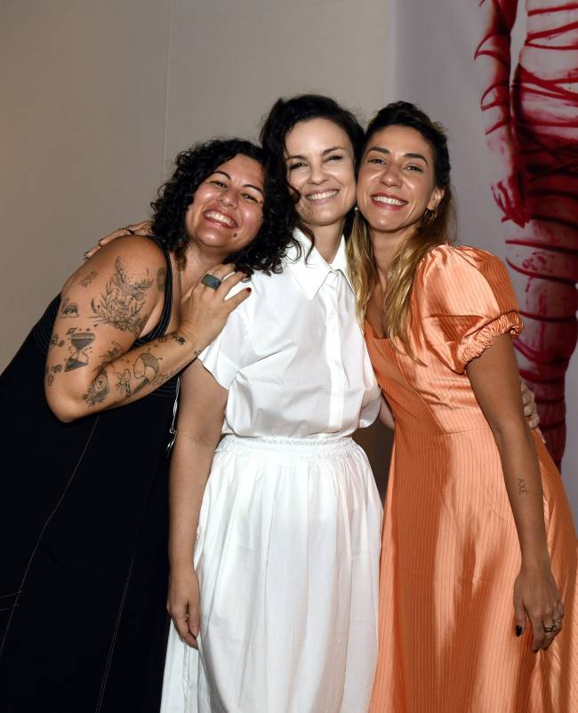 Carolina Kasting entre suas curadoras, Amanda Leite e Cota Azevedo